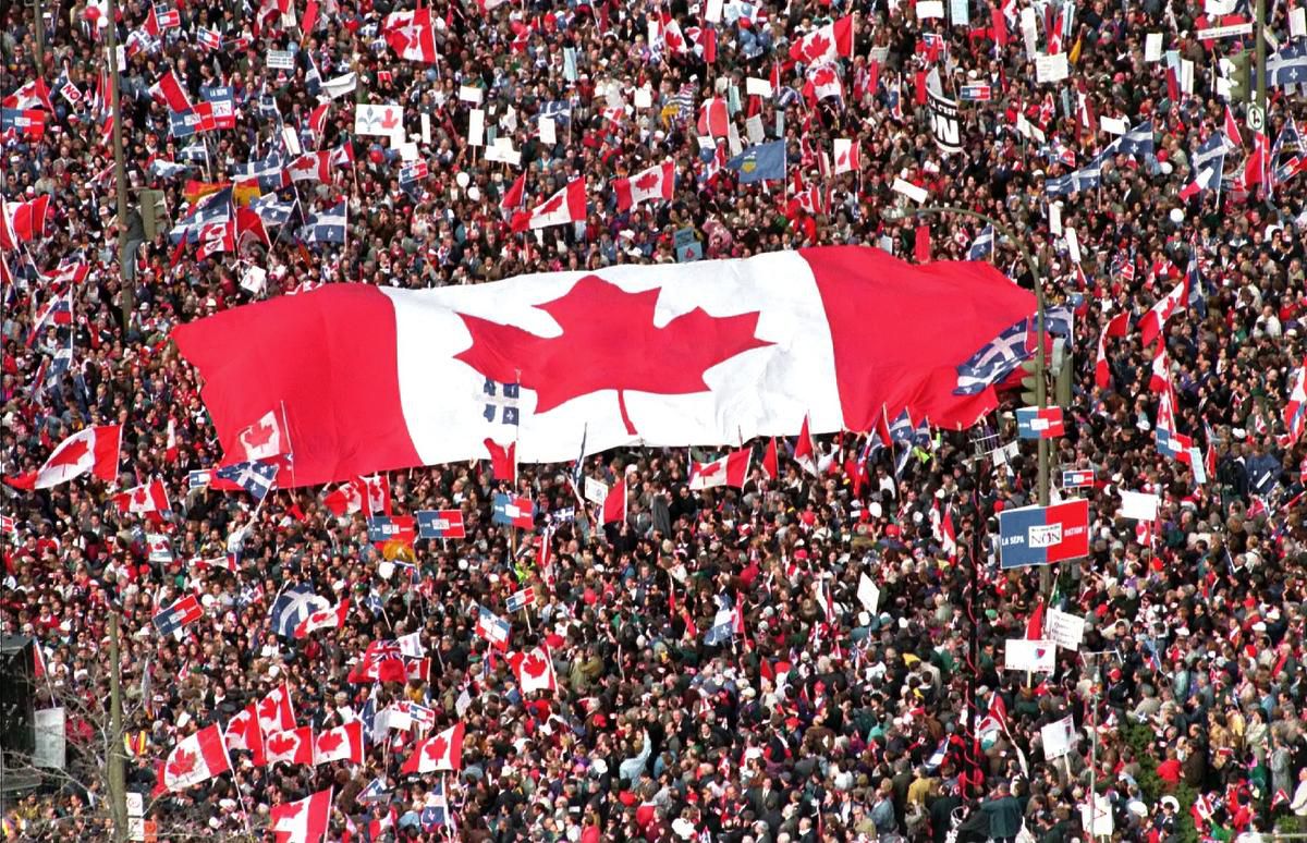 crowd holding Canadian flag