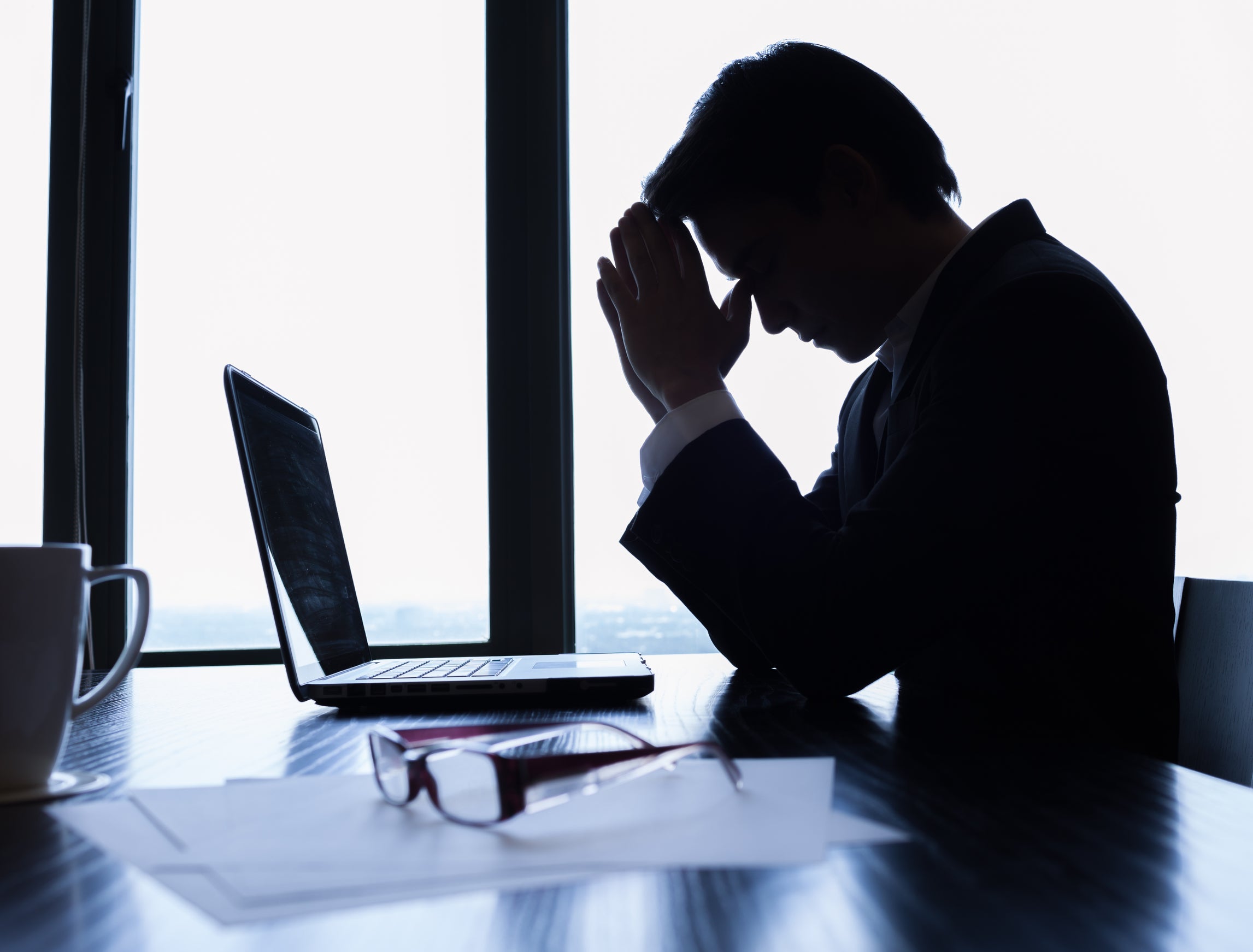 man praying at his desk