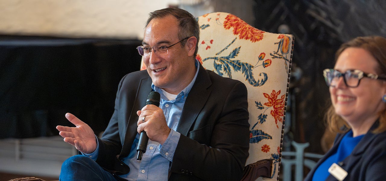 John Inazu speaking into a microphone