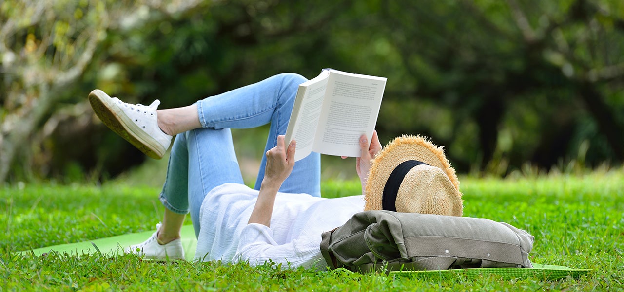 woman reading in the grass