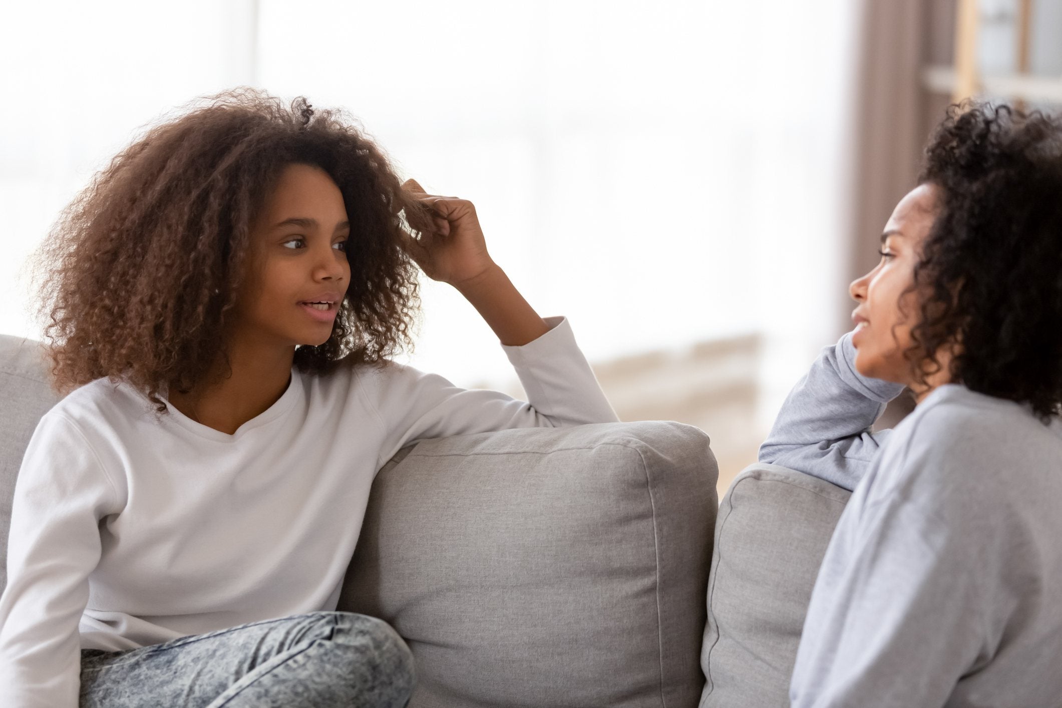 woman listening to a teenaged girl speaking