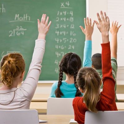 Image of students raising hands