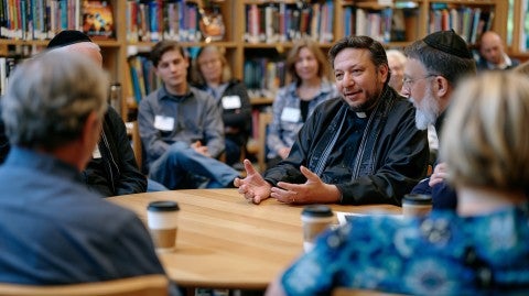 group of people speaking around a conference table