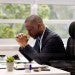 man praying at his desk