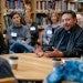 group of people speaking around a conference table